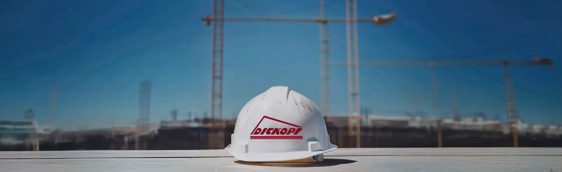 Dickopf-Bau Bauhelm Kran Startseite Logo Baustelle